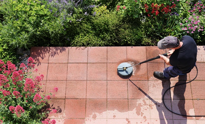 Man cleaning patio