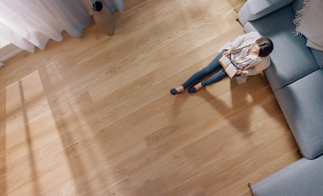 Woman sat on wood floor