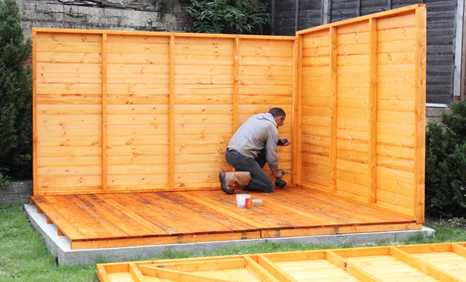 Man putting up shed