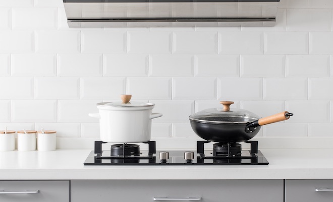 pans on a stove in white kitchen
