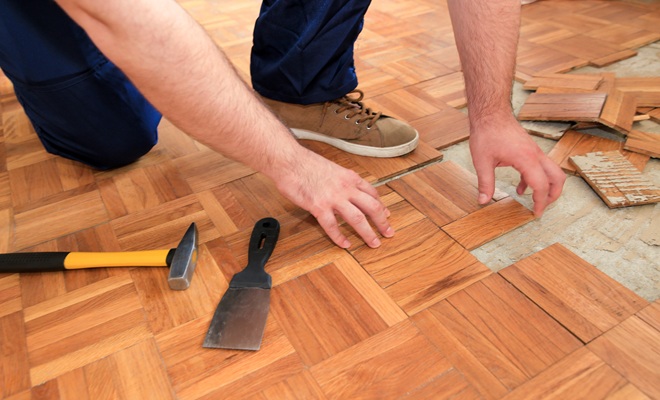 person removing flooring