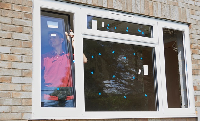 Man fitting window