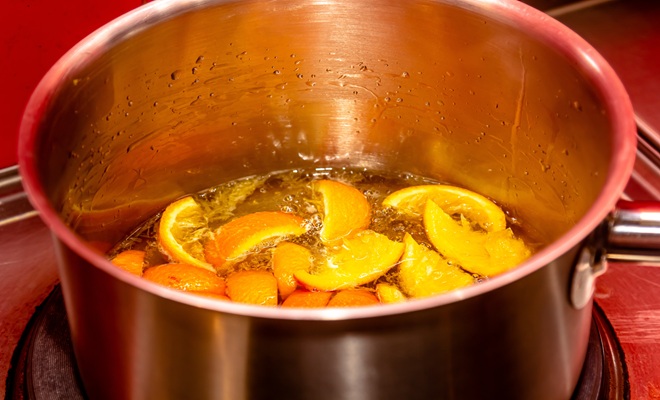 Oranges simmering in pan