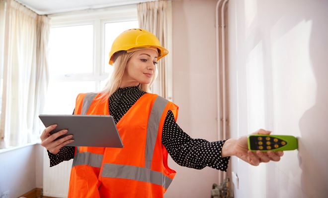 Woman with damp meter