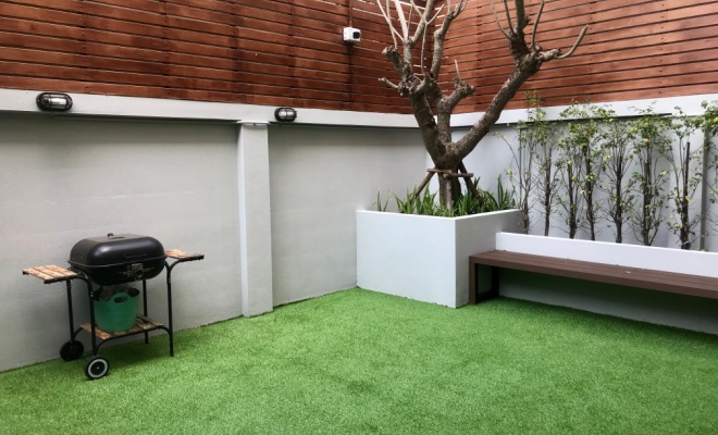 artificial grass and bbq in enclosed garden