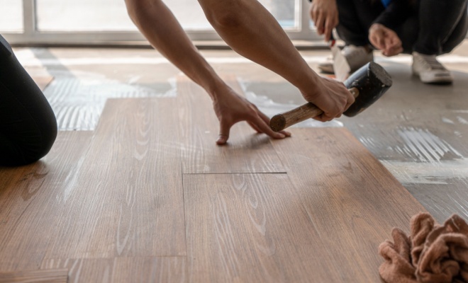 person installing vinyl flooring