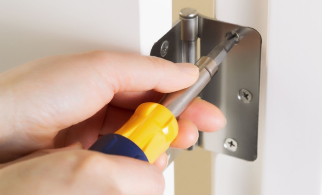 screwdriver working on hinge joint