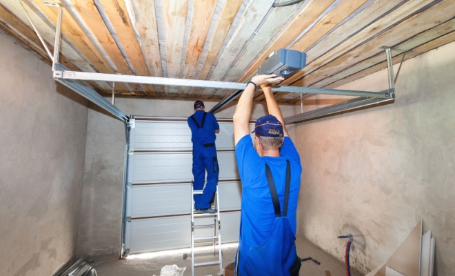 People replacing a garage door