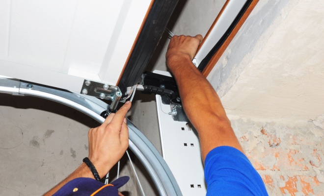 Man replacing garage door