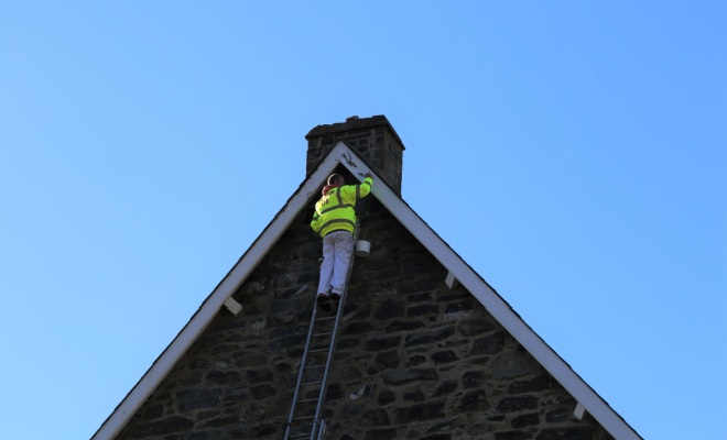 man replacing barge board