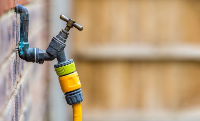 close up of a tap with hose attached