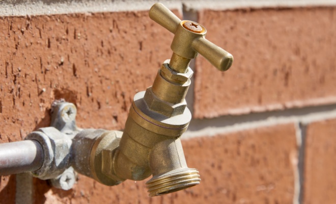 bright close up of bronze coloured outdoor tap