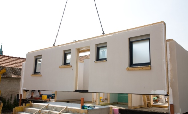 prefab wall being lowered to site