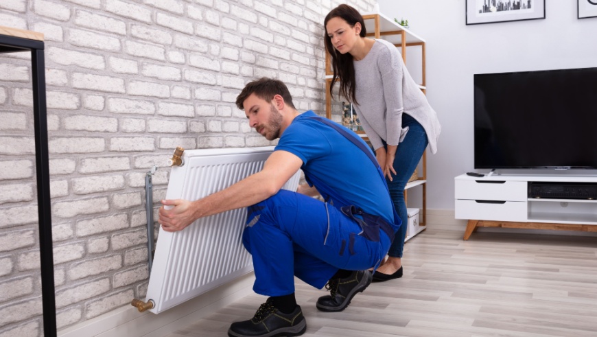 Tradesperson moving a radiator
