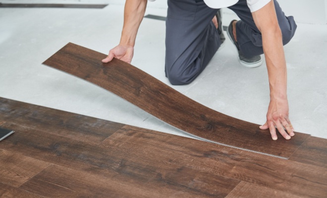 person fitting vinyl flooring