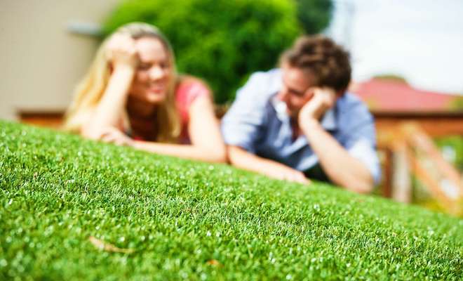 Blurred image of two people lying on artificial grass