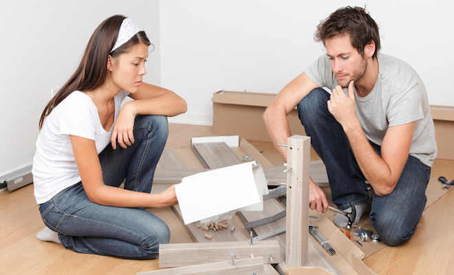 man and woman reading flat pack instructions