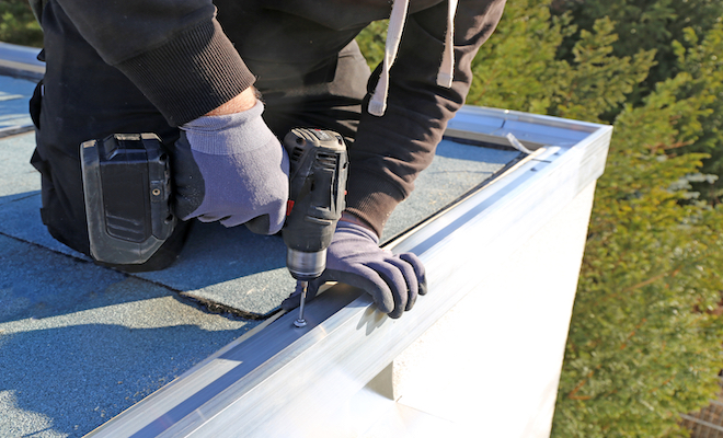 person replacing a garage roof