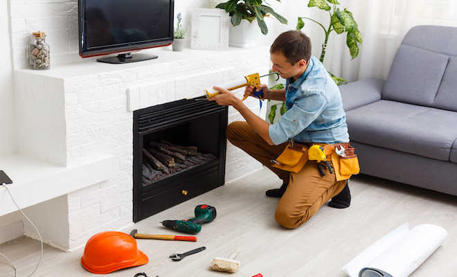 man moving a fireplace