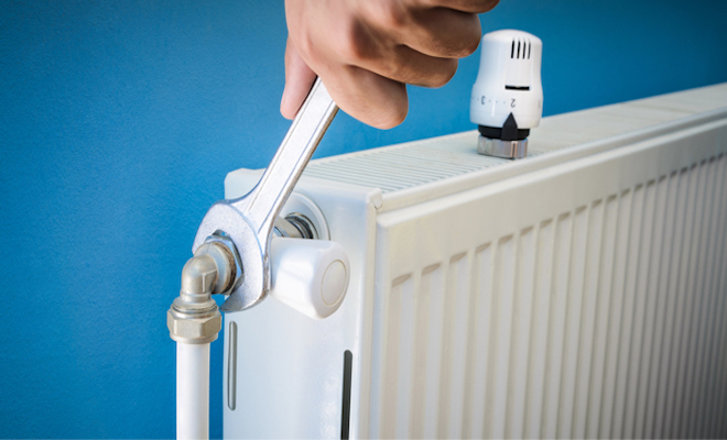 spanner being used on a radiator