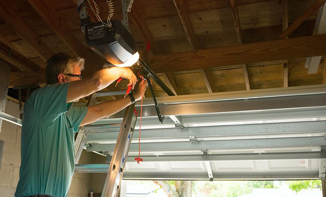 Man replacing garage door