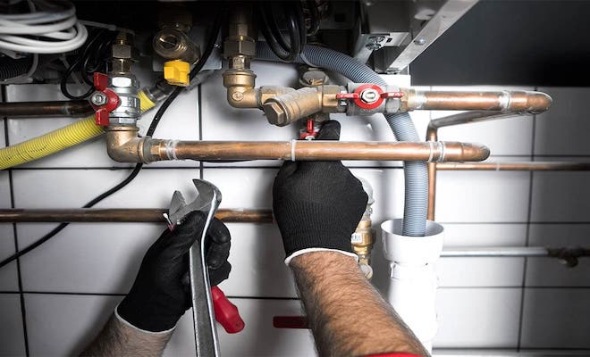 Tradesperson servicing a boiler