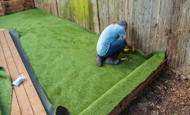 Man installing artificial grass