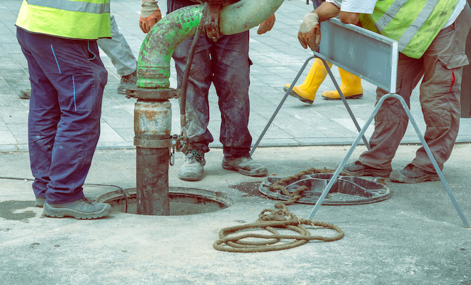 people cleaning drains