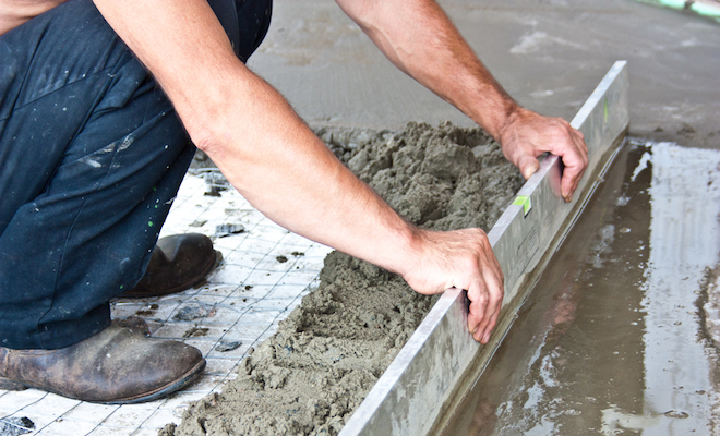 Tradesperson screeding floor