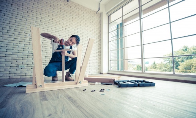 man working on assembling a table