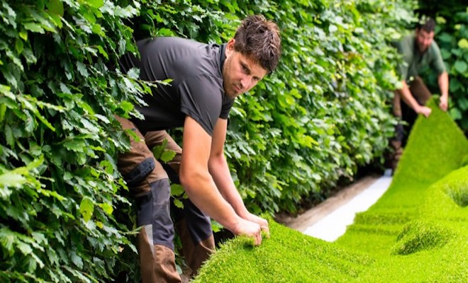 Man laying artificial grass