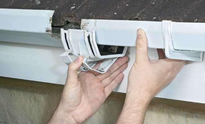 Tradesperson repairing a gutter