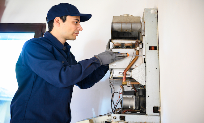 man working on a boiler