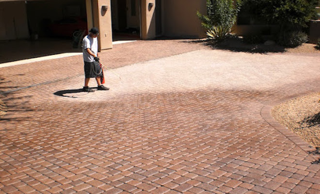 Man cleaning a patio