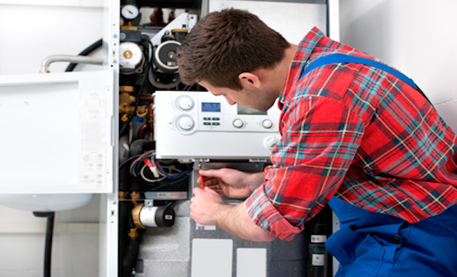 tradesman conducting boiler service