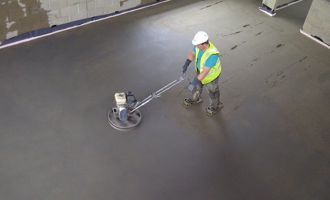 Man screeding large floor