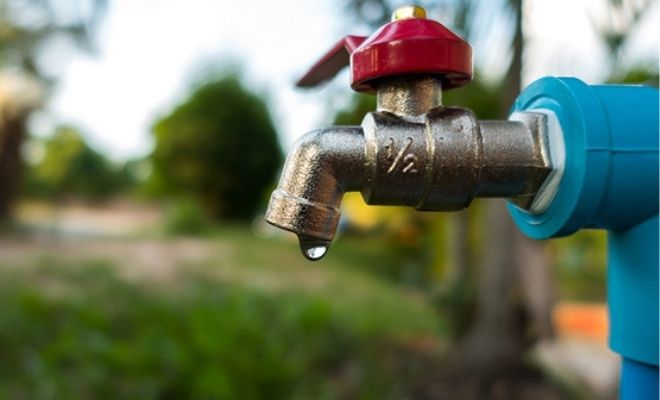 exterior tap with blurred garden background
