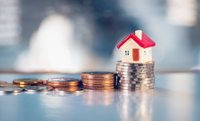 toy house on a stack of coin