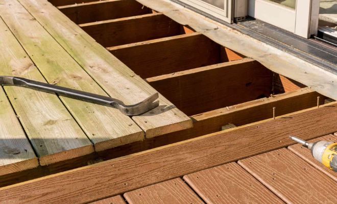 Removing floorboards with crowbar