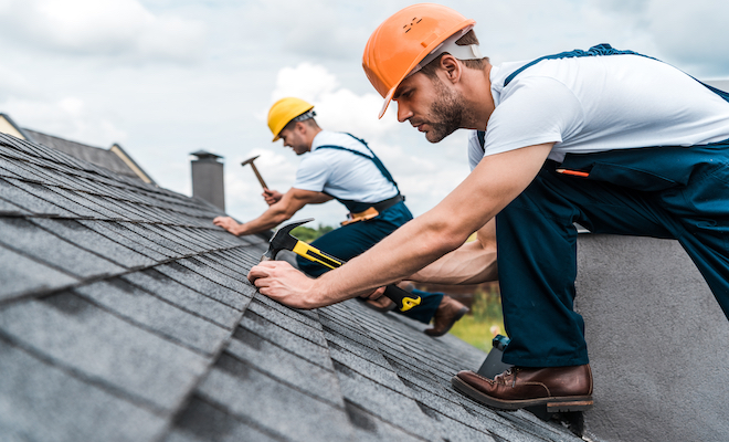 people tiling a roof