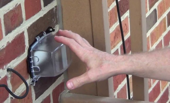 Hand touching outdoor socket