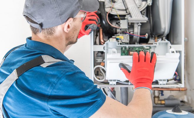 man servicing oil boiler