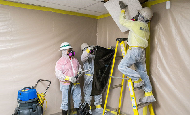 Men with wearing PPE during artex asbestos removal