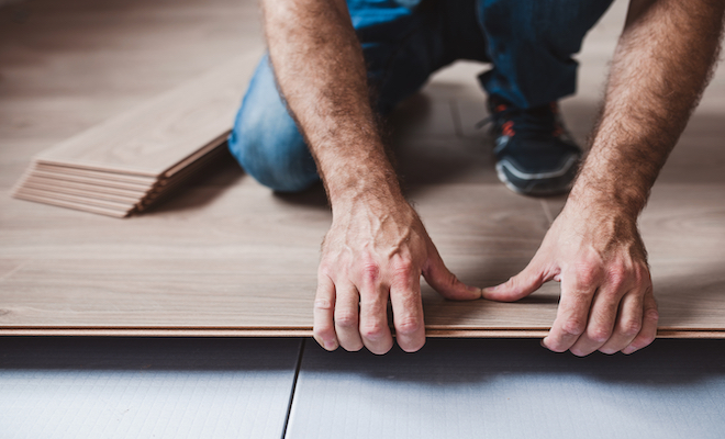 person installing vinyl flooring