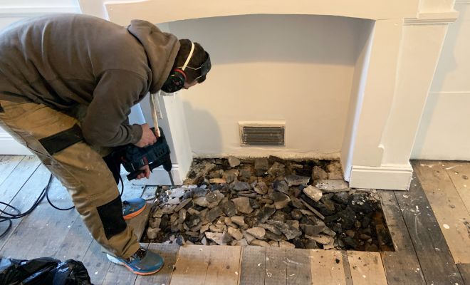 Floorboard removal around old fireplace