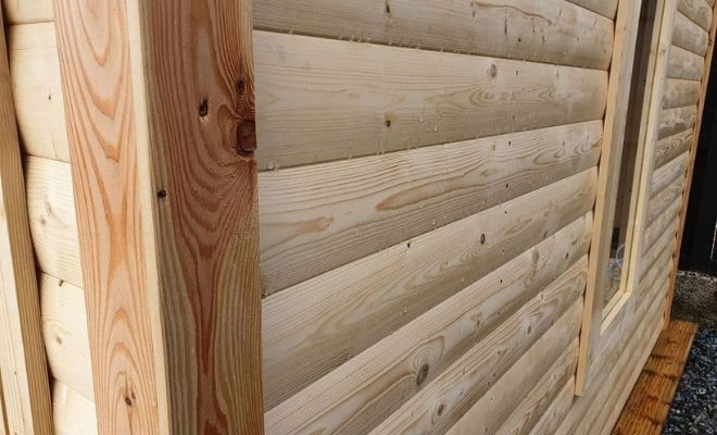 Timber log lap cladding