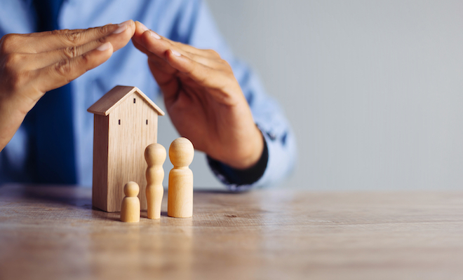 wooden house with wooden family figures