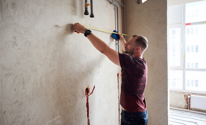 man measuring shower