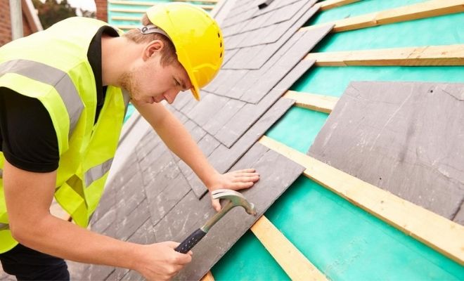 Man fixing roof tiles