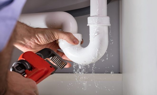 Plumber fixing a pipe